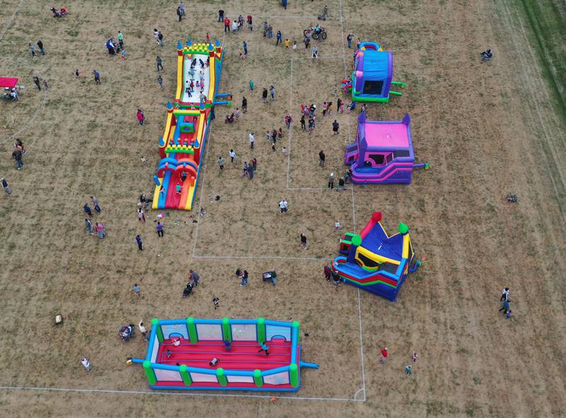 An aerial view of kids jumping on bounce houses at Zearing Park during the 52nd annual Homestead Festival on Friday, Sept. 8, 2023 in Princeton.