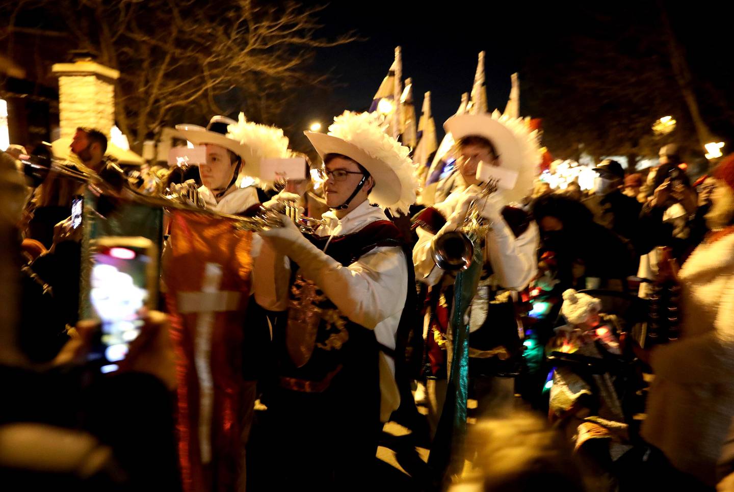 Performers parade on Third Street during the Geneva Christmas Walk