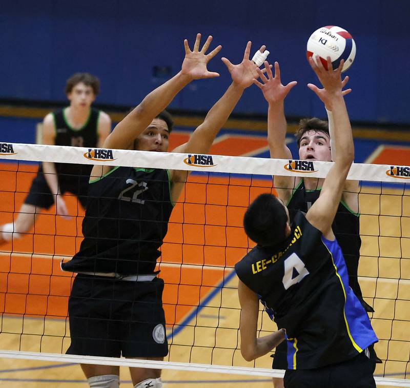 Glenbard West's Xzavion Willett (22) and Casey Maas (1) block a shot by Lyons' Brody Lee-Caracci (4) during the IHSA Boys Volleyball State Quarterfinals Friday May 31, 2024 in Hoffman Estates.