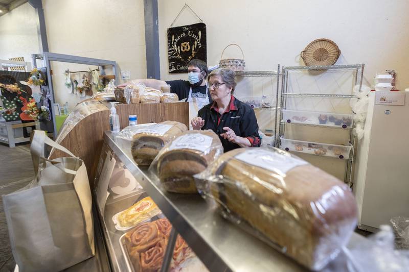 Dustin Gray and Joy Sosi of the Bakers Union sell breads rolls and other treats Saturday, March 25, 2023.