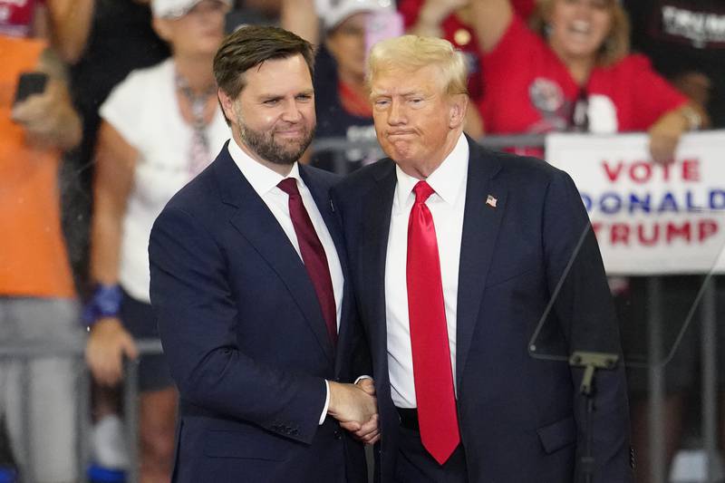 FILE - Republican vice presidential candidate Sen. JD Vance, R-Ohio, left, and Republican presidential candidate former President Donald Trump, shake hands at a campaign rally in Atlanta, Aug. 3, 2024. (AP Photo/Ben Gray, File)