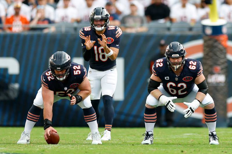 Chicago Bears quarterback Caleb Williams (18) waits for the ball from center Drew Dalman (52) during the second half of an NFL football game against the Dallas Cowboys, Sunday, Sept. 21, 2025, in Chicago. (AP Photo/Kamil Krzaczynski)