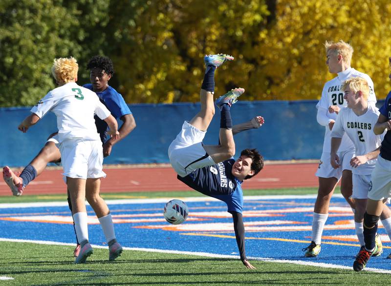 Chicago Academy's Jhostyn Lemus is up ended on a corner kick controled by Coal City Friday, Nov. 7, 2025, during their Class 1A state third place game at Hoffman Estates High School.
