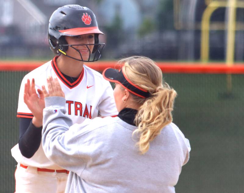Crystal Lake Central’s Lily Perocho is greeted at first base against Harvard in varsity softball at Crystal Lake Central High School in Crystal Lake on Monday, May 19, 2025.