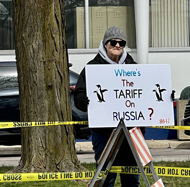 Protestors gather in front of the Grandon Civic Center and the post office on Saturday, April 5, in Sterling, to voice concerns over President Donald Trump and his administration.