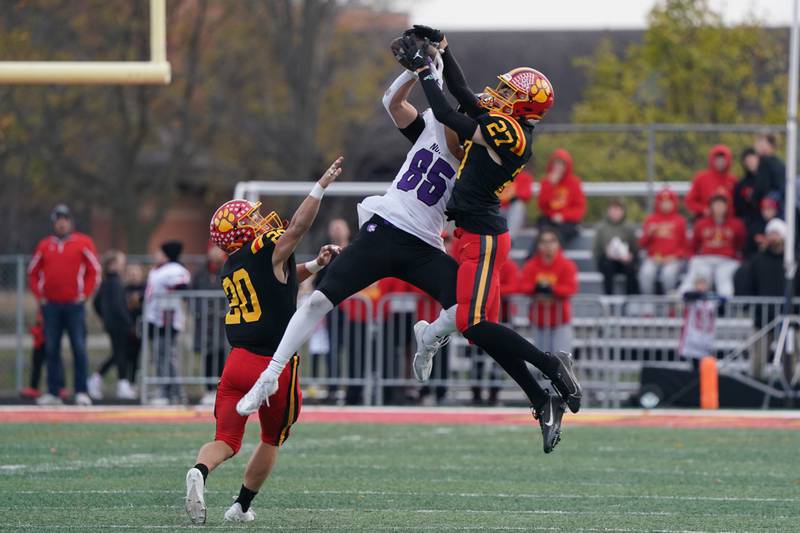 Downers Grove North's Will Vala (85) makes a circus catch against Batavia's Isaiah Brown (2) and Chase Osborne (20) during a class 7A quarterfinal playoff football game at Batavia High School on Saturday, Nov. 16, 2024.