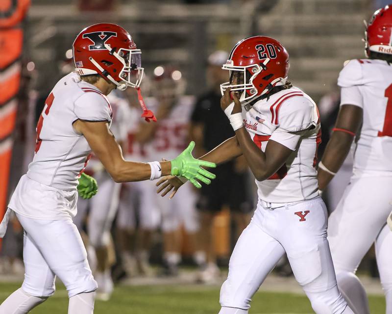 Yorkville's Tyvon Wilson (R) is greeted by Hunter Niklos (6) after coming up with a sack during football game between Yorkville at Plainfield East Friday, Sept 19, 2025 in Plainfield.