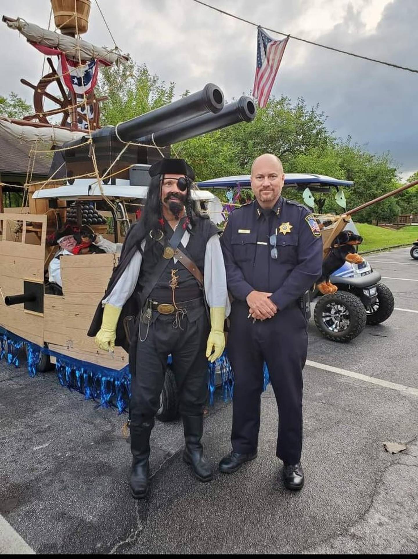 Braidwood resident Greg Machak said he built a 24-foot long, 12-foot high, fully drivable Navy destroyer – a USS Hollister – on a golf cart. Machak is pictured on the left and Todd Lyons, Braidwood chief of police, is on the right.