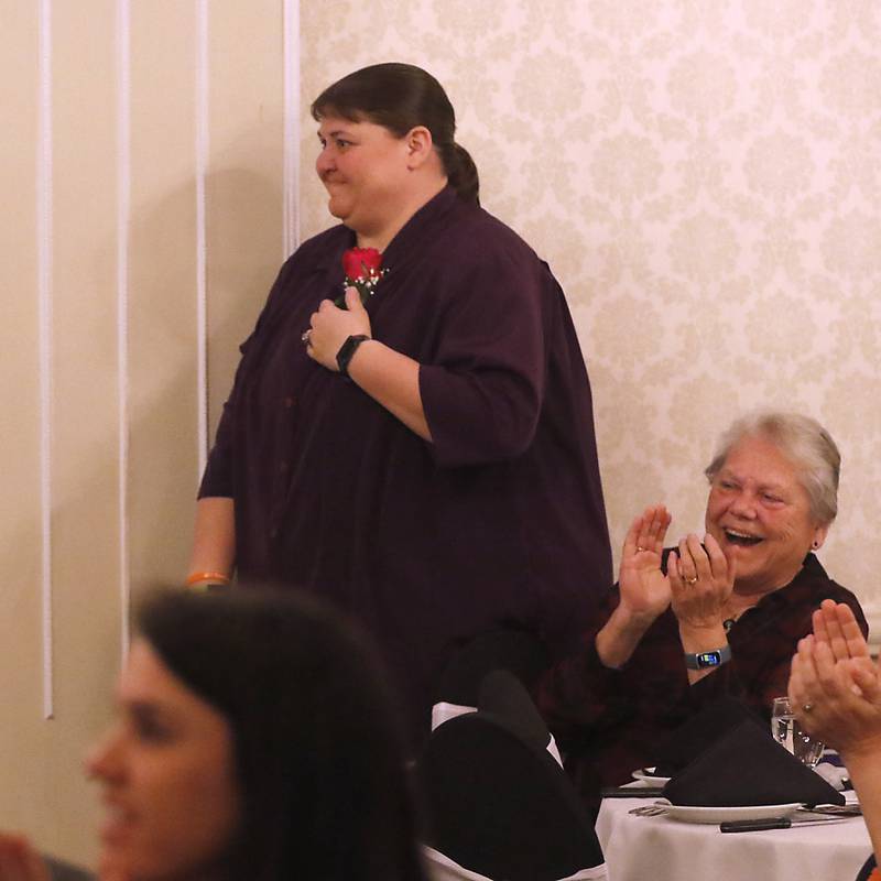 Renae St. Clair of Huntley High School reacts to winning the 2023 Educator of the Year award as Jan Welch claps for her during the the Educator of the Year Dinner, Saturday, May 6, 2023, at Hickory Hall, in Crystal Lake. The annual awards recognize McHenry County’s top teachers, administrators and support staff.