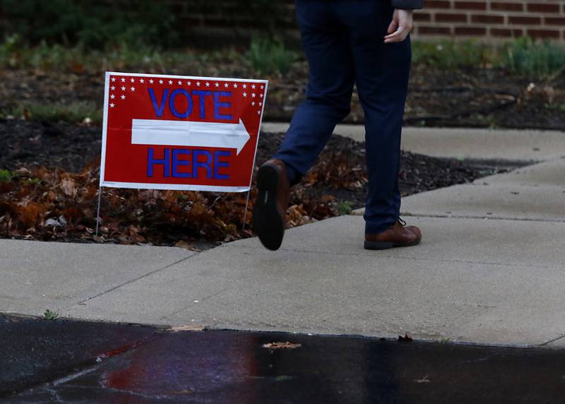 A voter walks past a vote here signs  on Tuesday, Nov. 5, 2024, at the Johnsburg Public Library.