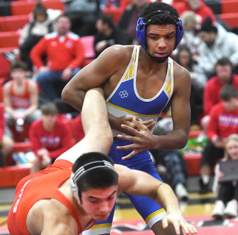 Johnsburg's Jordan Sylvanus hangs on to the leg of Oregon's Cole Suter as they wrestle in a 165-pound match at the Stillman Valley Holiday Tournament on Saturday, Dec. 20, 2025 at Stillman Valley High School.