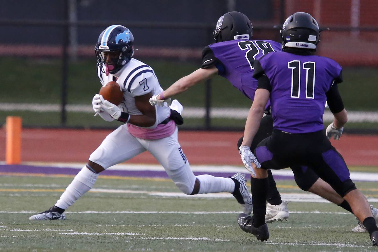 Downers Grove South’s Eli Reed (left) tries to avoid getting tackled by Downers Grove North’s Josh Lambert during their football game at Downers Grove North High School in Downers Grove on Friday, April 23, 2021.