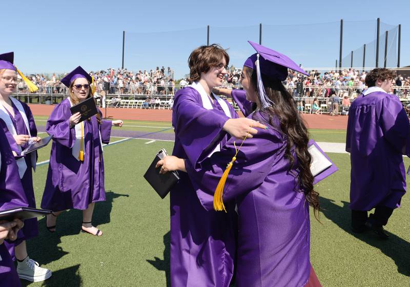 Downers Grove North graduates (left) Ashton Sosnow and Jocelyn Torres embrace in a hug after their graduation ceremony Sunday May 21, 2023.