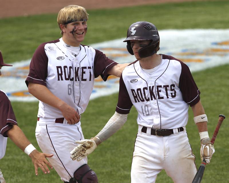 Richmon-Burton’s Hayden Christiansen, and Connor Wallace celebrate a run during a IHSA Class 2A supersectional baseball game between Richmond-Burton and Timothy Christian at the Rockford Rivets Stadium in Rockford.