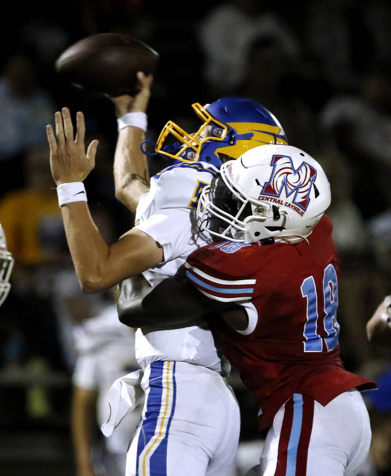 Marian Central's Nate Sarfo, right, hits Johnsburg's Anthony Bravieri as he trows a pass during a non-conference football game Friday, Sept. 2, 2022, between Marian Central and Johnsburg at Marian Central High School.