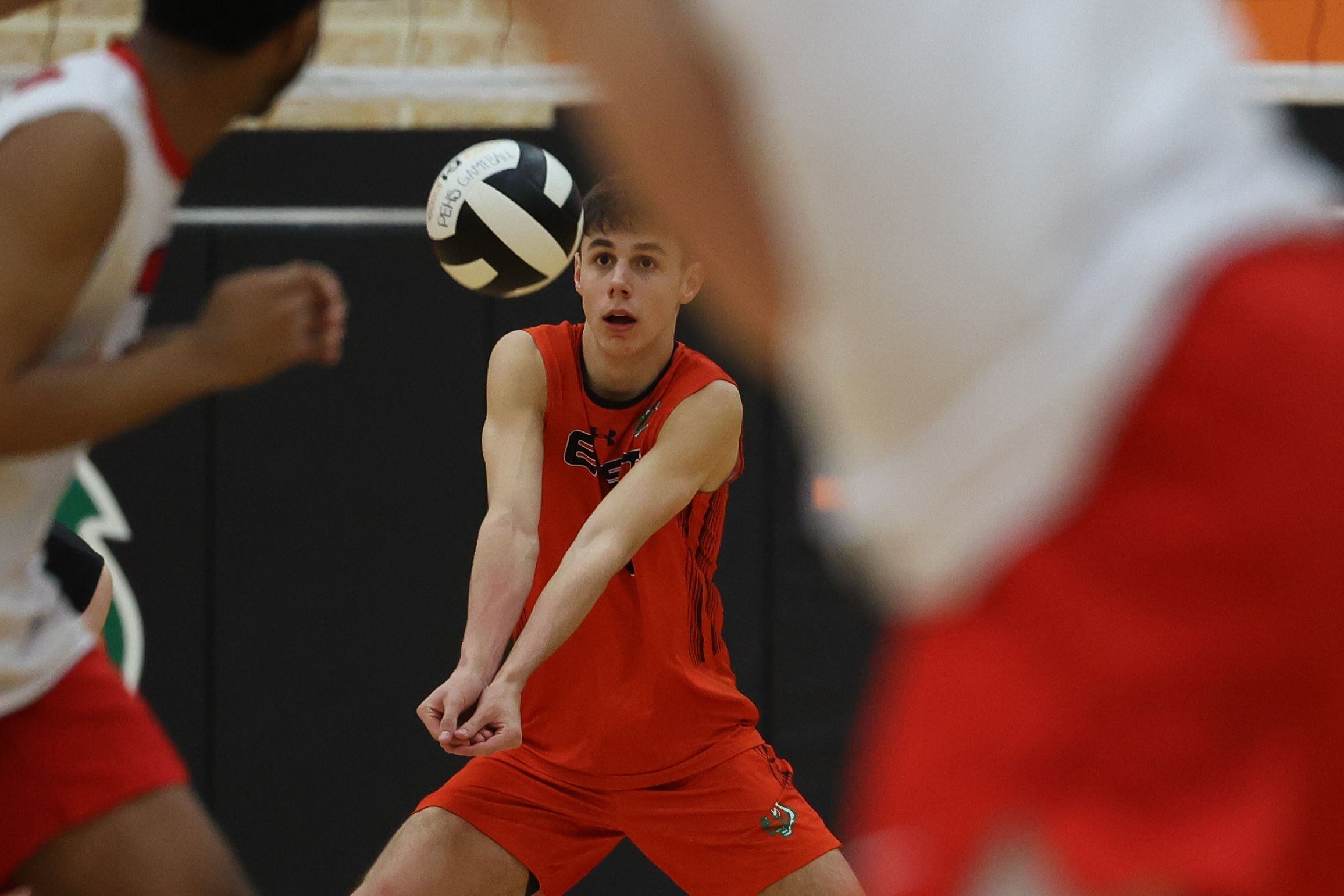 Plainfield East’s Nathan Grutza receives a serve against Bolingbrook in Plainfield.