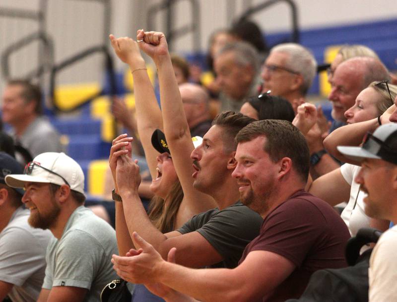 Fans cheer at Johnsburg High School during an alumni basketball game between Johnsburg alumni Skyhawks against the McHenry alumni Warriors Saturday evening to benefit the family of Jackson Werderitch, a 10-year-old who was struck by a car.