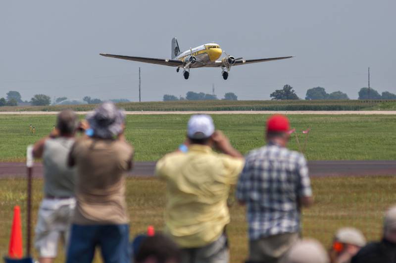 Flying enthusiasts watch as the DC-3 takes off near the start of the air show Saturday, July 24, 2021 in Rock Falls. The plane transported the Misty Blues skydiving team to start the show.