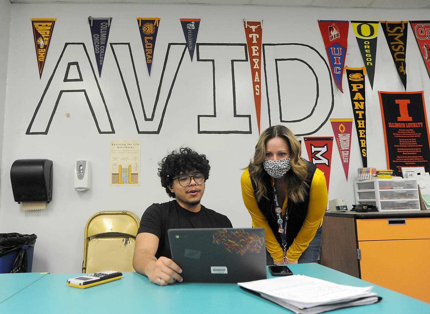 Teacher Kristin Fries talks with student Adam Vera on Tuesday, March 22, 2022, as she teaches the Advancement Via Individual Determination, or AVID, class for seniors at Jacobs High School in Algonquin.