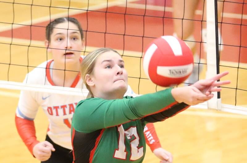 L-P's Emma Jereb saves the ball from going out of play as Ottawa's Mary Stisser looks on from behind the net on Thursday, Oct. 17, 2024 in Kingman Gym at Ottawa High School.