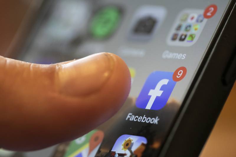 FILE - An iPhone displays the Facebook app, Aug. 11, 2019, in New Orleans. Russia, China and Iran are continuing to target voters in the U.S. with disinformation and propaganda related to the upcoming presidential election, top intelligence officials told reporters on Monday, July 29, 2024. Groups linked to the Kremlin are increasingly using private public relations firms or unwitting social media users to spread their false claims as a way to hide their tracks. (AP Photo/Jenny Kane, File)