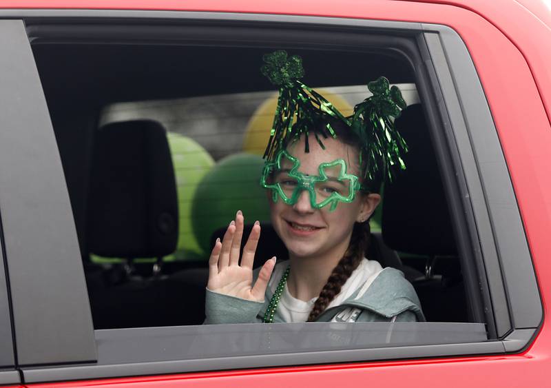 A girls waves from the Pavement Solutions truck during the McHenry ShamROCKS the Fox Festival Parade on Saturday, March 14, 2026. In McHenry.