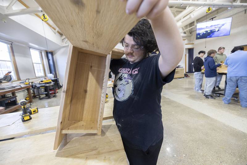 Sterling High School student Christian Cardott displays the wood duck house Monday, Nov. 10, 2025, he built recently. The class was asked to build the houses for a local conservation group.