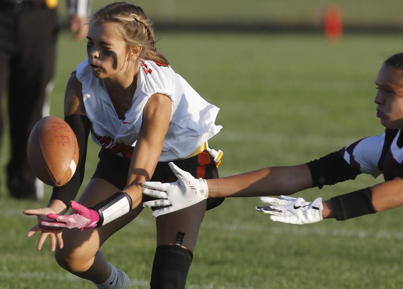 Crystal Lake Central's Ella Mueller intercepts a pass in intended for Prairie Ridge’s Lila Stewart during a girls flag football game on Thursday, Sept. 4, 2025, at Prairie Ridge High School in Crystal Lake.