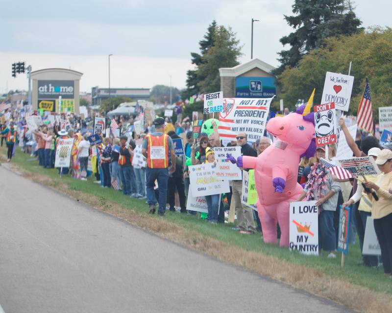 Locals gather at the NO Kings rally along Randall Rd. on Saturday, Oct.18,2025 in Geneva.