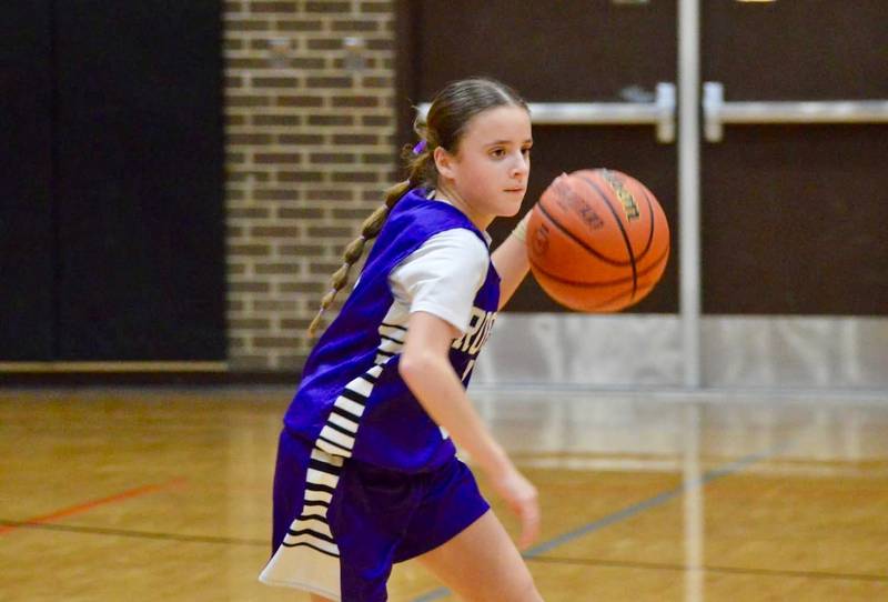 Rochelle's Campbell Adolph dribbles the ball during a seventh grade basketball game in DeKalb.