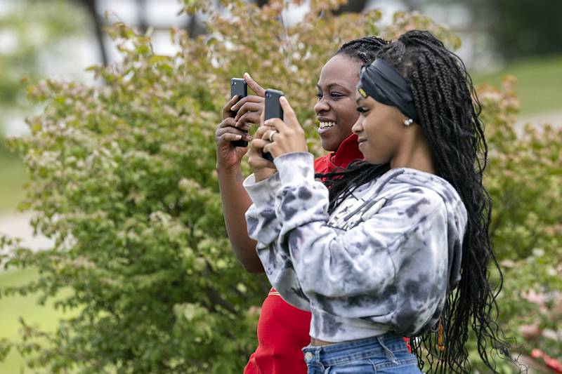 Felicia (left) and Kabriyah Croswell take videos Saturday, Aug. 17, 2024, at the Rock Falls River Chase. The two recently moved to the area and were excited to see the unique event.