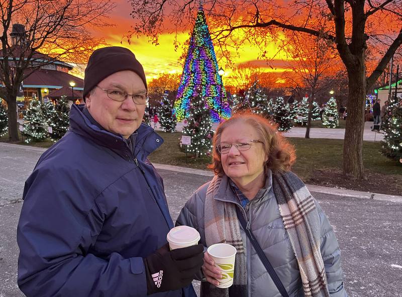 Gerry and Joyce Jablonski, zoo members from Chicago, enjoy the sunset and some hot chocolate at the start of the Holiday Lights festivities on Dec. 7, 2024 at Brookfield Zoo.