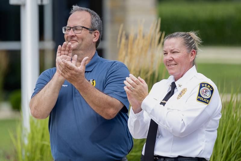 (left to right) Mayor Ken Kolowski and Chief Sarah Raymond clap during the Juvenile Police Academy graduation ceremony on Friday, July 25, 2025 at the Peru Police Department in Peru.