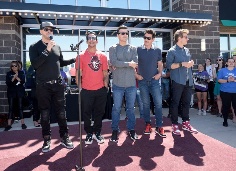 New Kids on the Block band members Donnie Wahlberg, Danny Wood, Jordan Knight, Jonathan Knight, Joey McIntyre (L-R) take the stage for the Wahlk of Fame Ceremony at the Wahlburgers in St. Charles on Saturday, June 18, 2022.