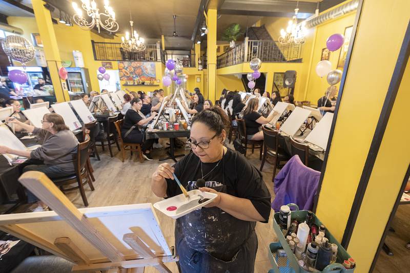 Primitive Frills owner and paint party organizer Sonia Robinson leads the group as they start their Selena portraits Monday, April 15, 2024. Selena was born on April 16, 1971.
