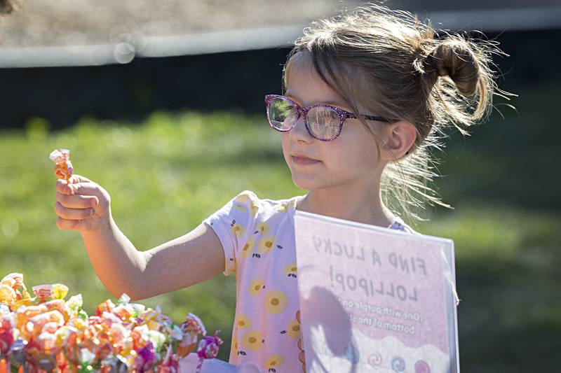 Emilia Rodgers, 5, chooses a lollipop for a prize Thursday, August 31, 2023 while attending the Dixon PTO back to school fun day.