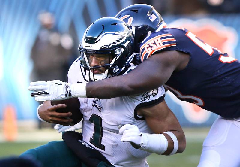 Chicago Bears linebacker Nicholas Morrow brings down Philadelphia Eagles quarterback Jalen Hurts during their game Sunday, Dec. 18, 2022, at Soldier Field in Chicago.
