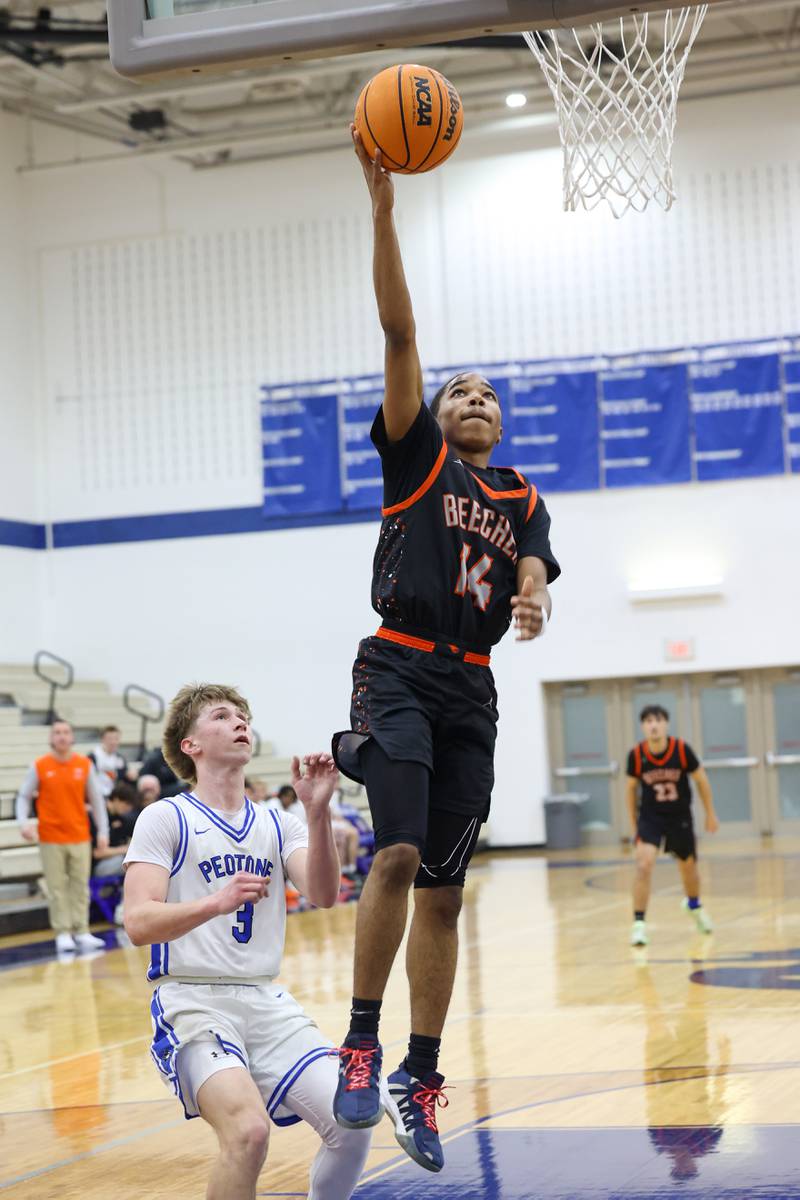 Beecher's Aaron Harden hits a layup past Peotone's Nick Cronin during the Blue Devils' 64-52 victory over Beecher on Wednesday, Jan. 28, 2026.