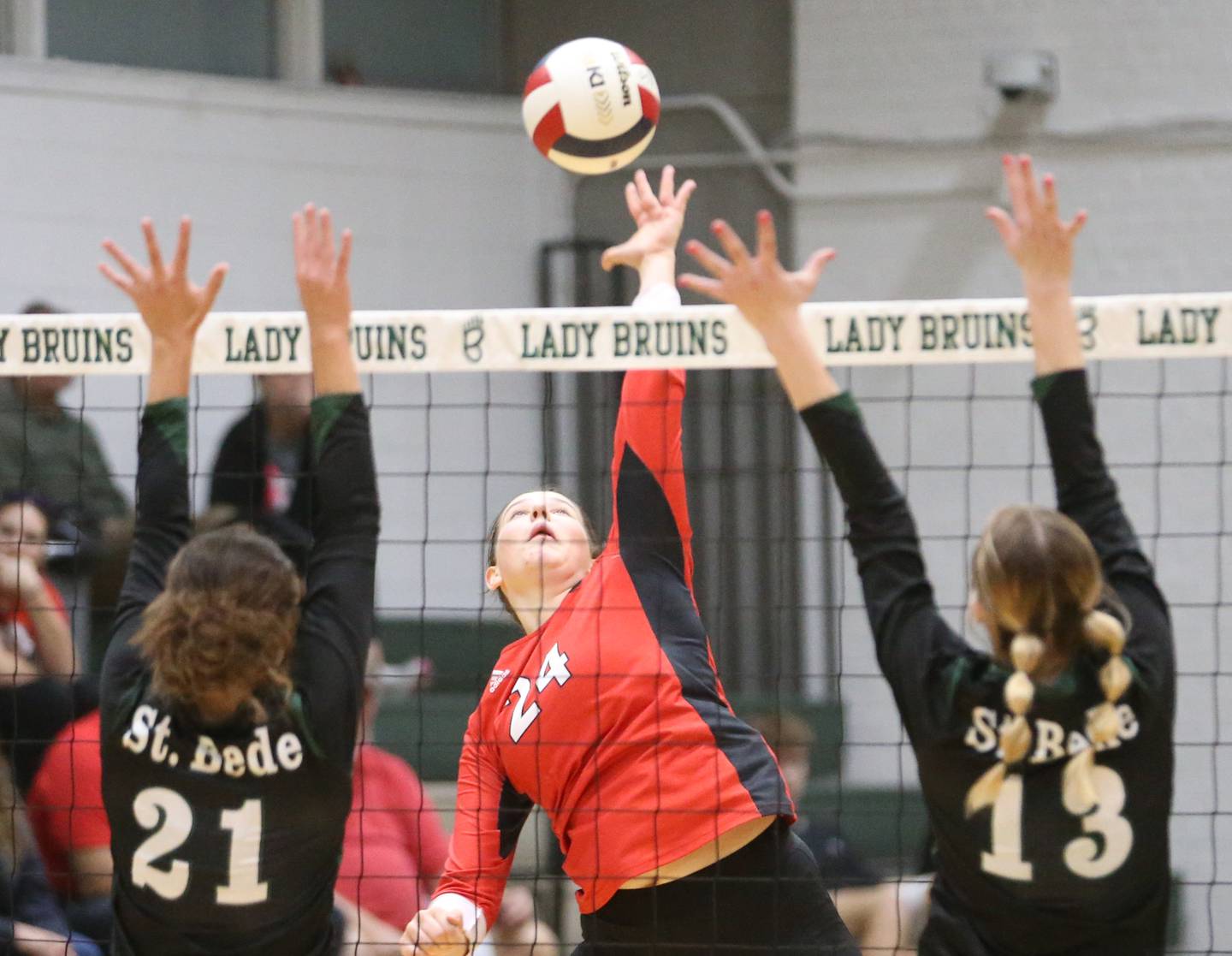 Henry-Senachwine's Harper Schrock sends a kill past St. Bede's Lily Bosnich and teammate Ashlyn Ehm during the Class 1A Regional final game on Thursday, Oct. 31, 2024 at St. Bede Academy.