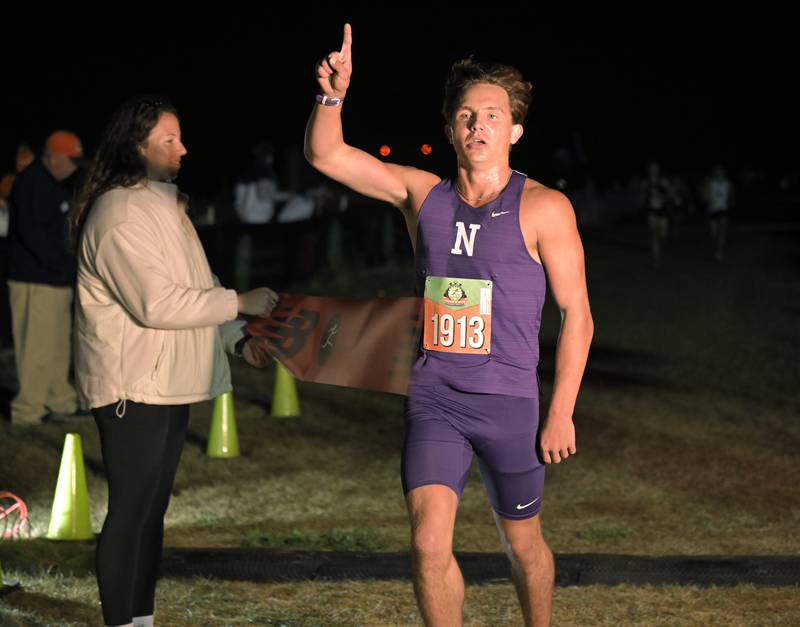 Philip Cupial of Downers Grove North wins the boys varsity race at the annual Naperville North Twilight Cross Country meet, this year at Settler’s Hill in Geneva on Wednesday, Oct. 8, 2025.
