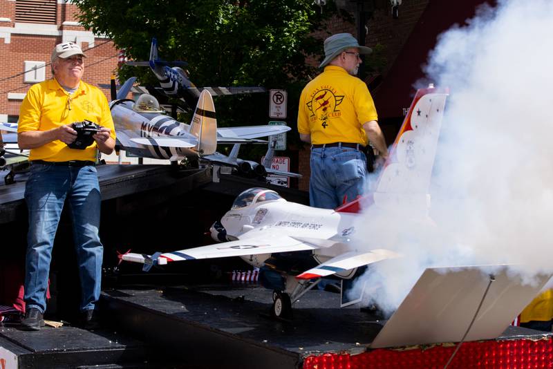 Dave Murray of the Fox Valley Aero Club releases steam from the back of a remote control airplane during the St. Charles Memorial Day Parade in downtown St. Charles on Monday, May 26, 2025.