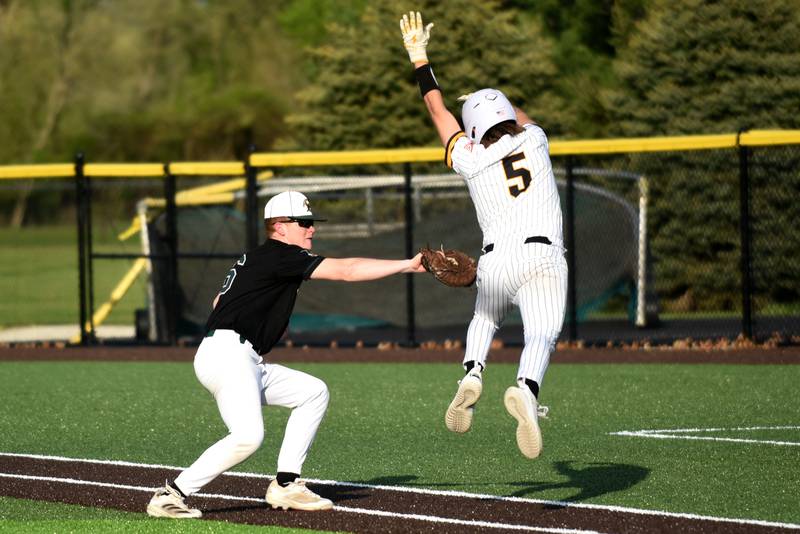 Coal City's Ethan Olson, left, attempts to tag Reed-Custer's Collin Monroe after Monroe's squeeze bunt during a game at Reed-Custer Tuesday, May 6, 2025.