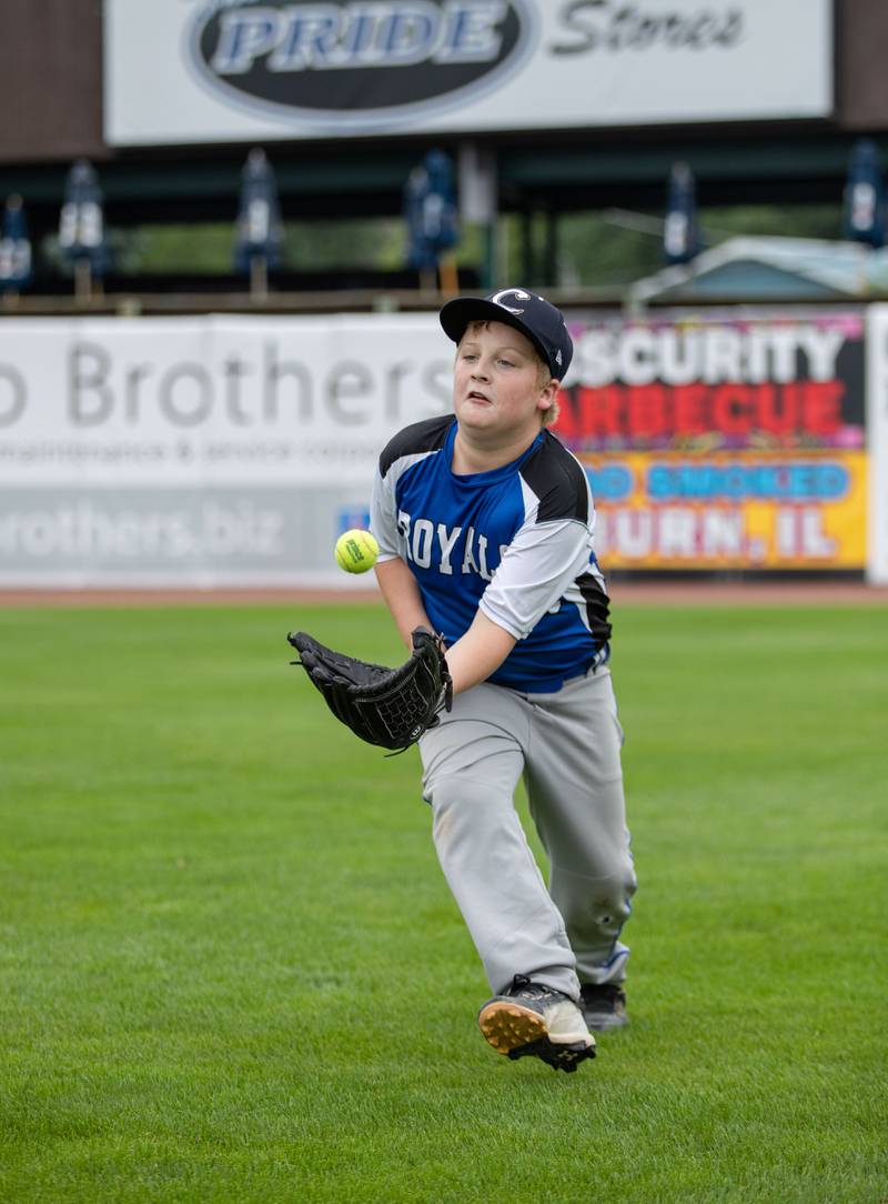 Hunter Heiss (11) of Big Rock catches a fly ball at the outfield station of the Kane County Cougar's Youth Clinic at Northwestern Medicine Field on Saturday, July 16, 2022.