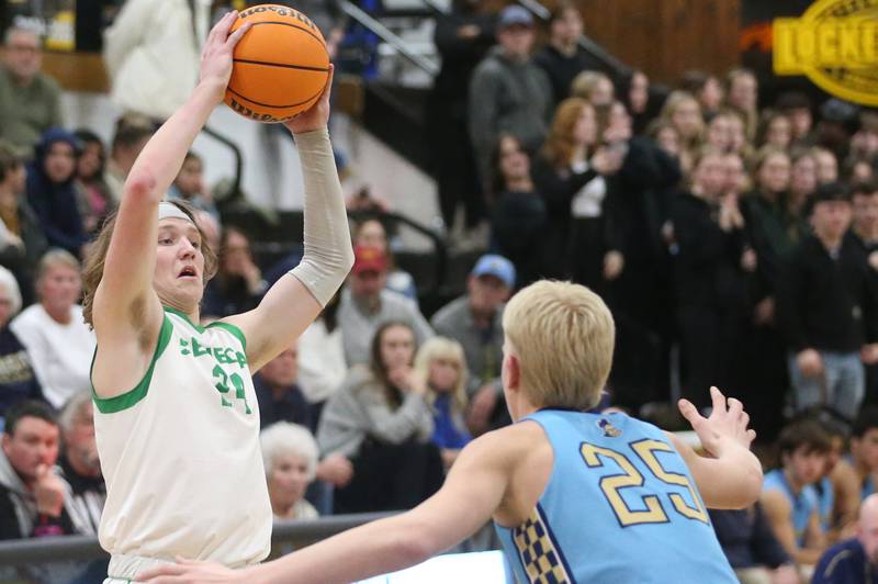 Seneca's Grant Siegel passes the ball over Marquette's Luke McCullough during the Tri-County Conference championship on Friday, Jan. 31, 2025 at Putnam County High School.