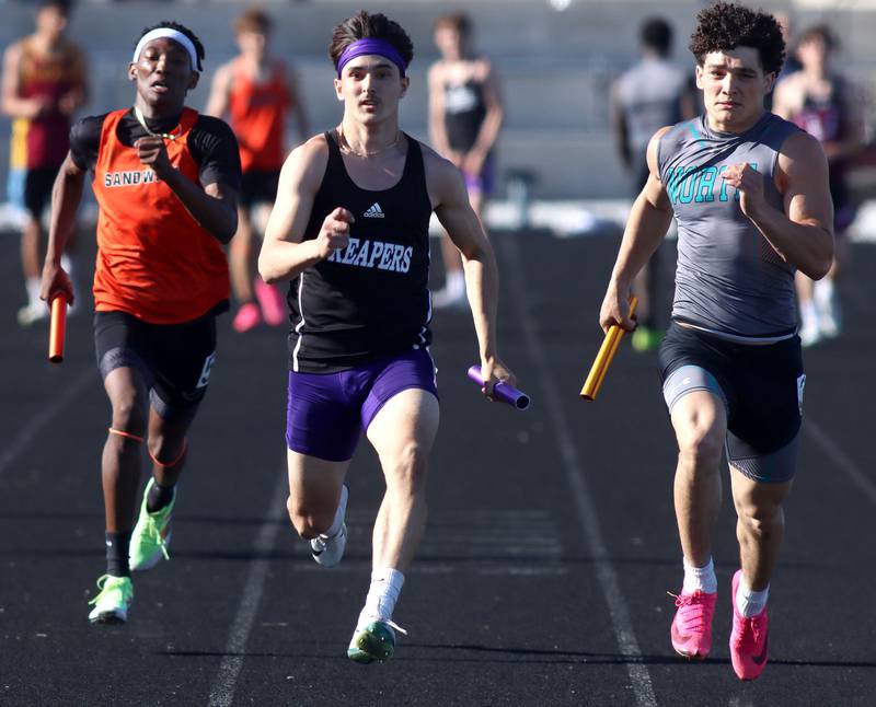 Plano’s Tristan Meszaros, center, anchors the 400-meter relay in KRC Conference Track Meet action at Richmond-Burton High School in Richmond on Tuesday, May 13, 2025. At left is Sandwich’s Devin Adams-Dunn and at right is Woodstock North’s George Kingos.