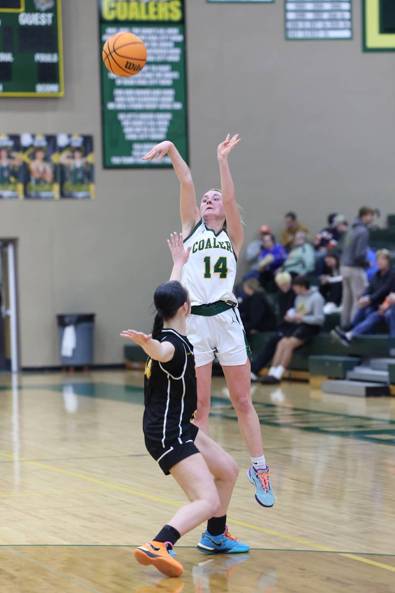 Coal City's Riley Walker shoots a 3-pointer over Reed-Custer's Atiana Hood during the Comets' 50-43 victory over Coal City on Monday, Jan. 11, 2026.