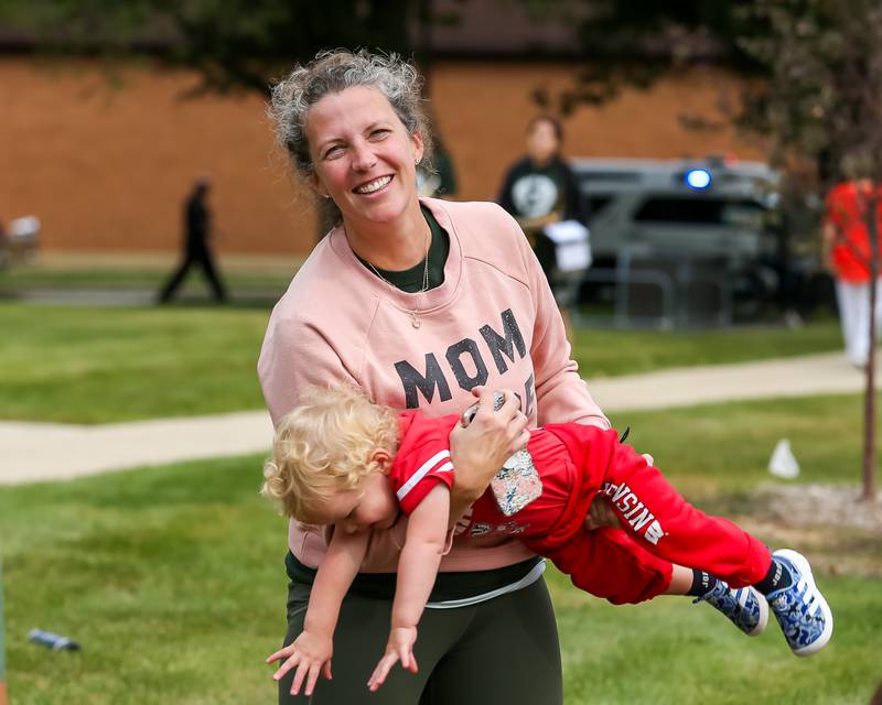 Jen Juridico plays with her son Matteo at the Glenbard West Homecoming Parade.  Sept 16, 2023