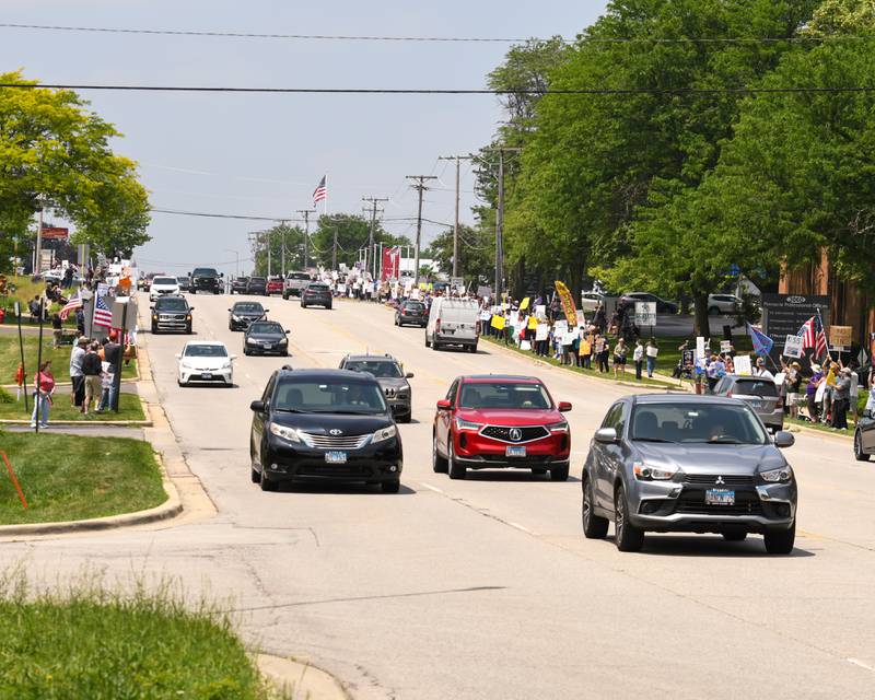 Community members line both sides of Ogden Ave. on Saturday June 14, 2025, during the No Kings rally held near the Tesla dealership in Lisle.
