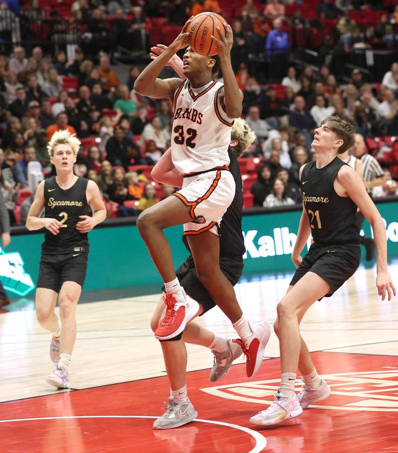DeKalb’s Justin O’Neal gets to the basket ahead of two Sycamore defenders Friday, Jan. 26, 2024, during the FNBO Challenge in the Convocation Center at Northern Illinois University.