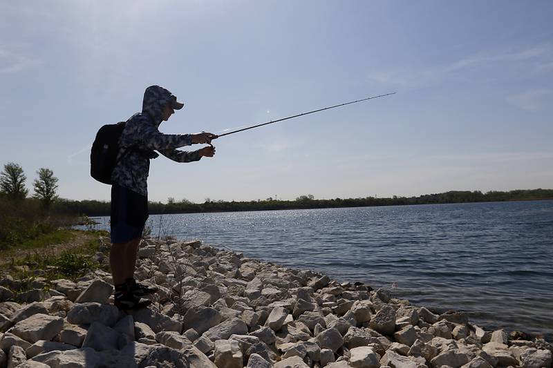 Kamil Bakowicz, 20, of Elk Grove Village, fishes along the shoreline Thursday, May 11, 2023, at Three Oaks Recreation Area in Crystal Lake.